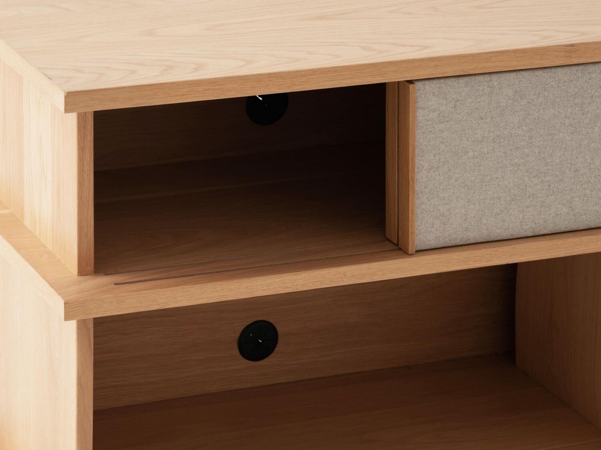 Detail view of the Plank tall modern media console in oak with drawers open and fabric panels